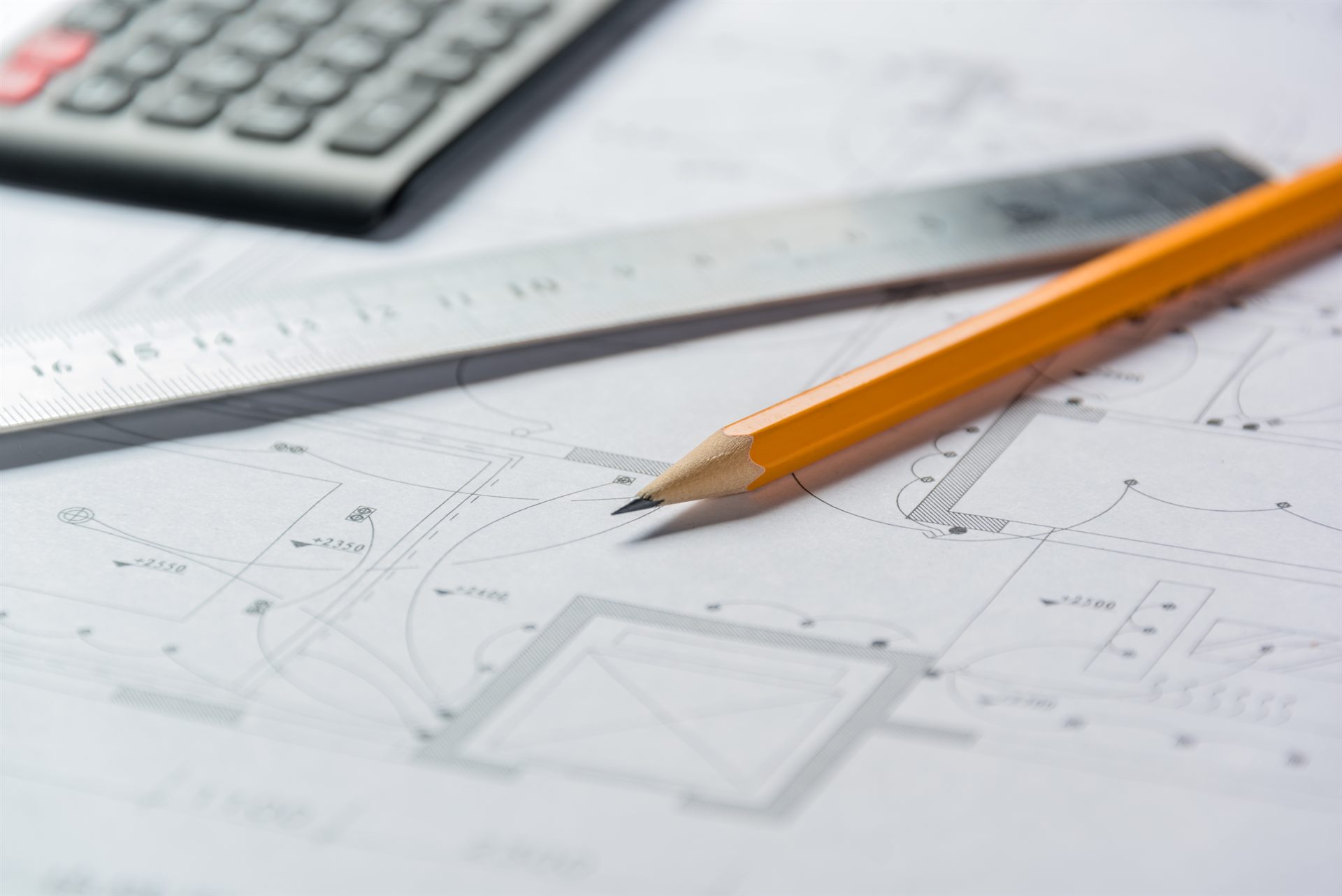 Drafting instruments resting on a technical plan