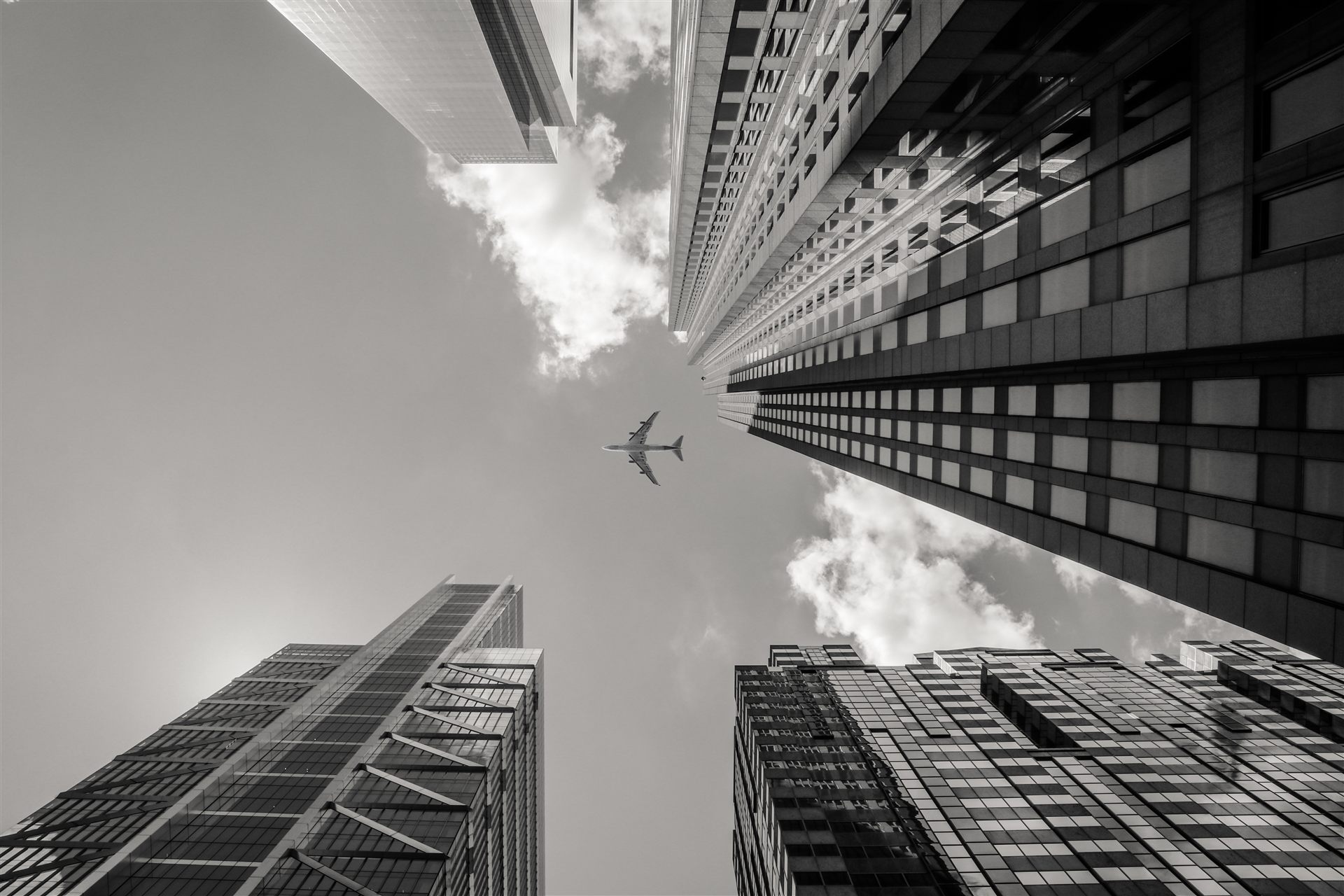A plane crossing the sky between towers