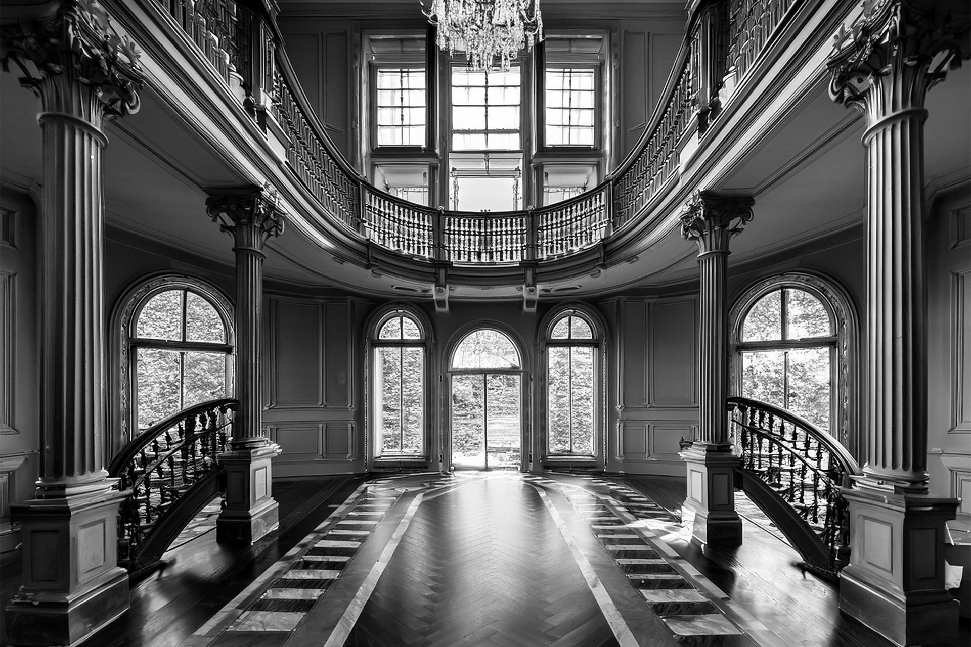 A double staircase in a panelled hall