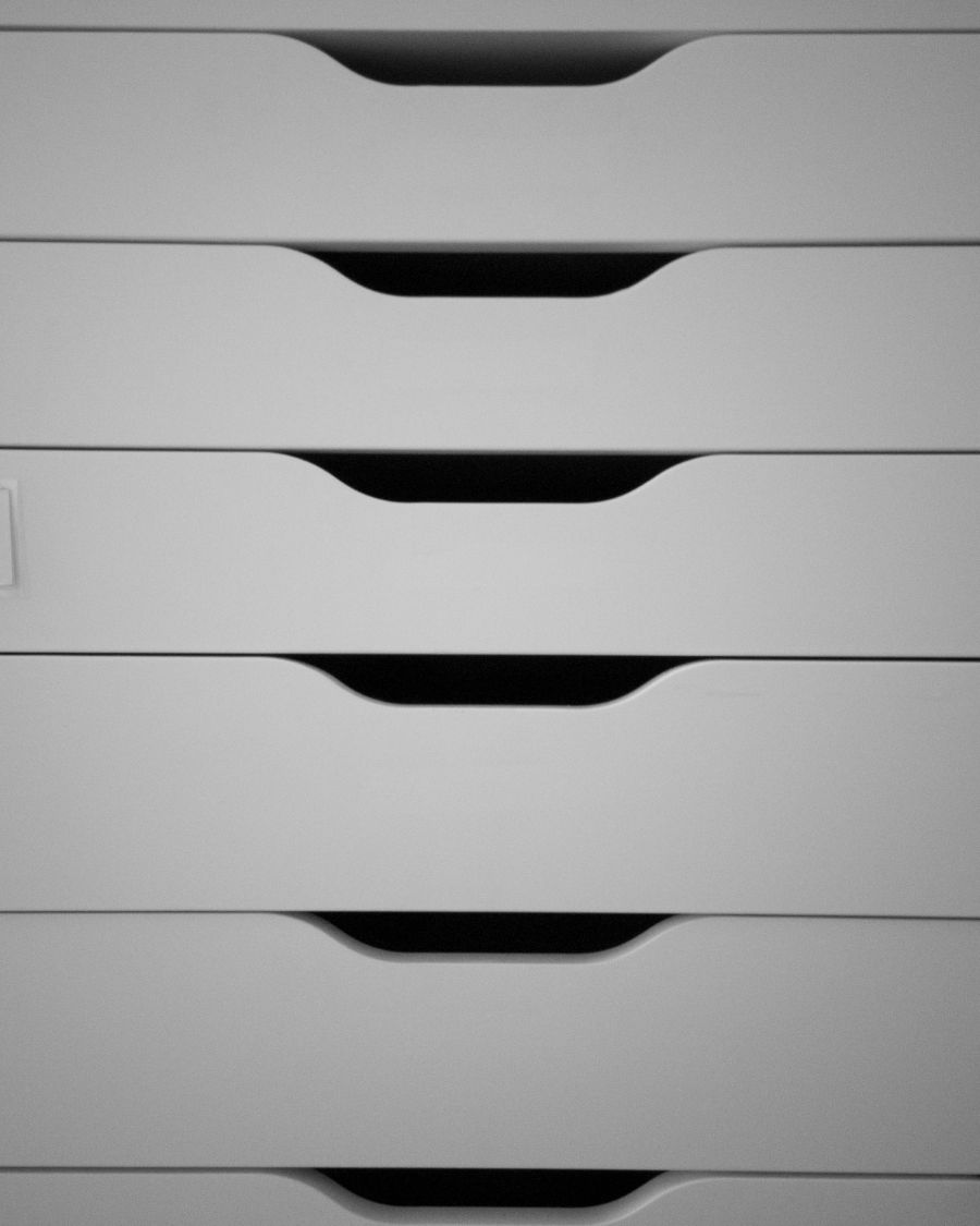 Stacked white office drawers with cut-out handles