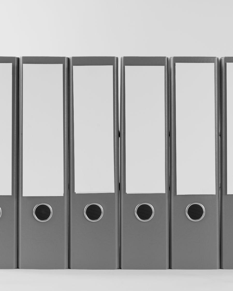 A row of grey lever-arch files with finger holes