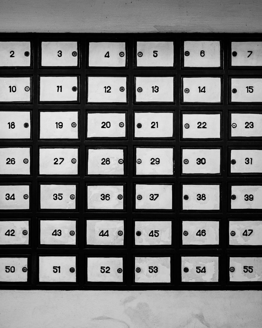 A wall of numbered mailboxes