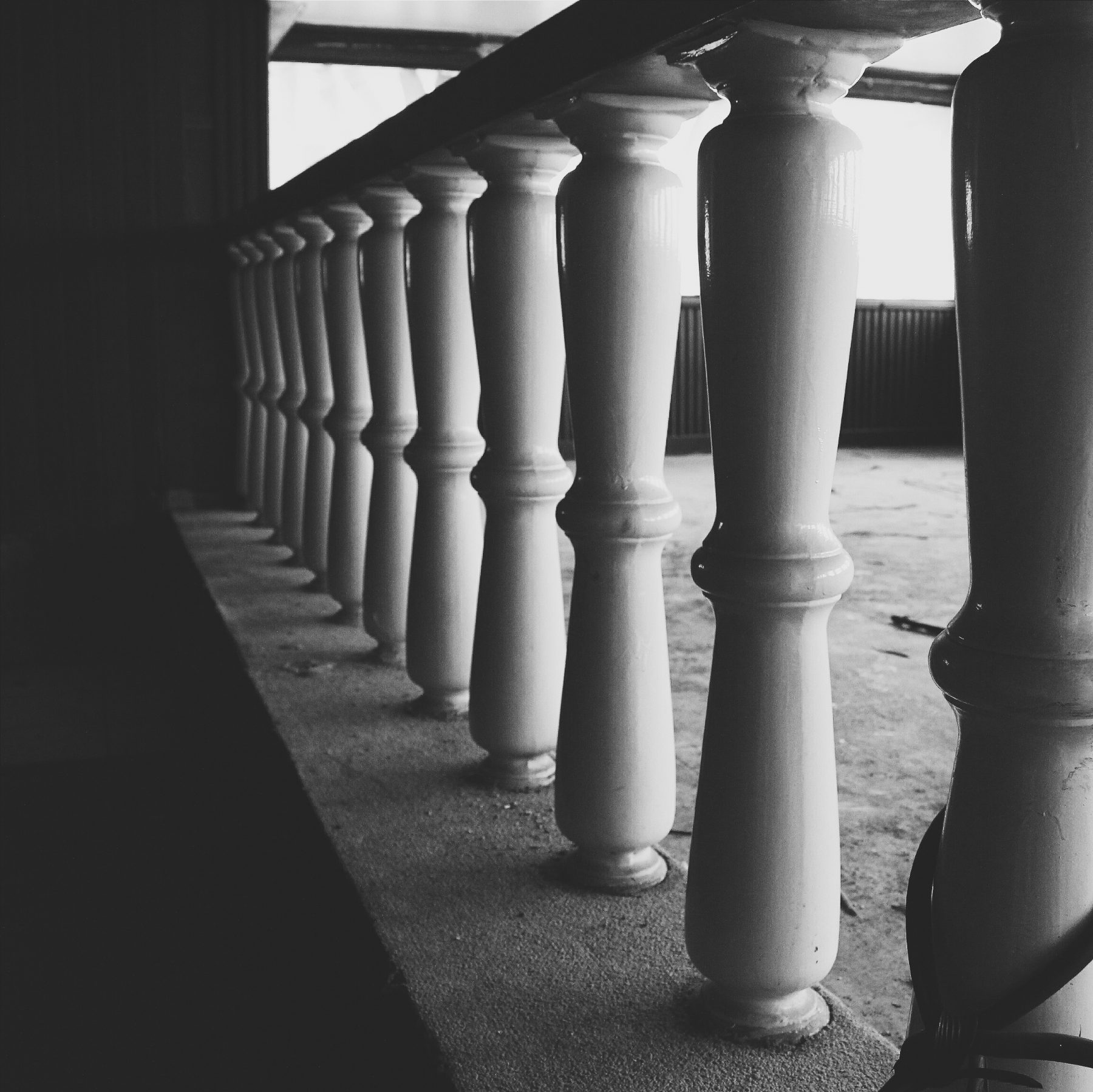 A row of stone balusters in black and white